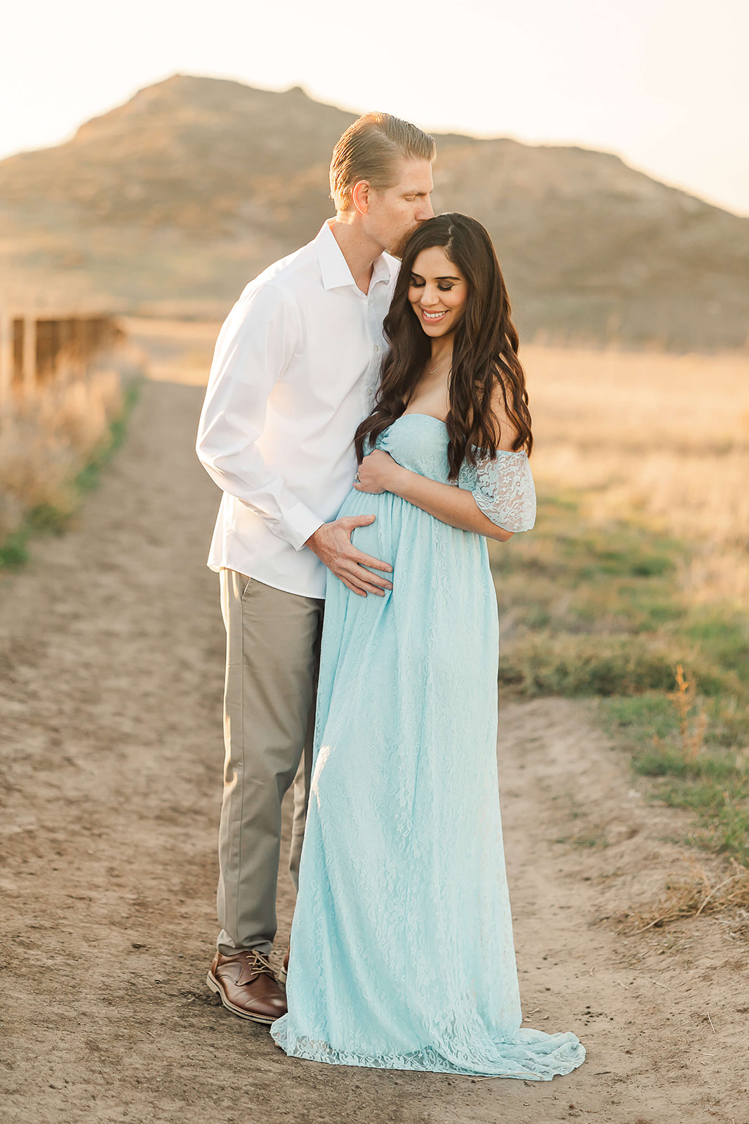 dad to be cradling his wife's baby bump Birthing centers in Orange County