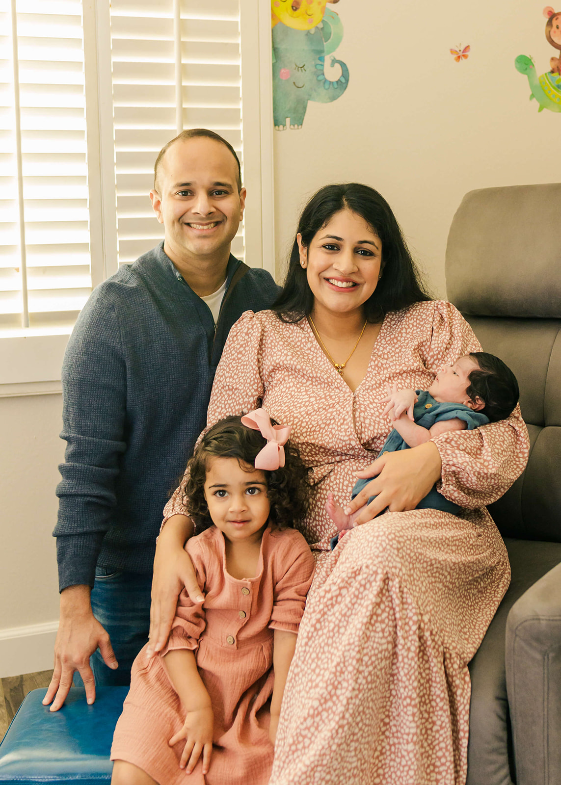 new family of four sitting in the living room orange county pediatricians
