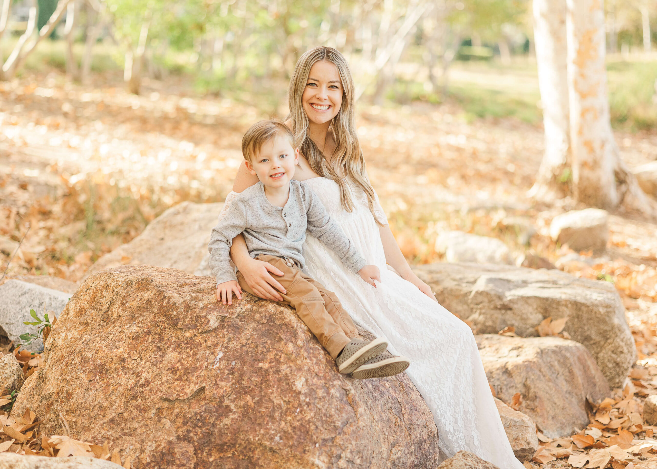 Mama and son sitting on a rock during maternity session by Ashley Nicole Photography.