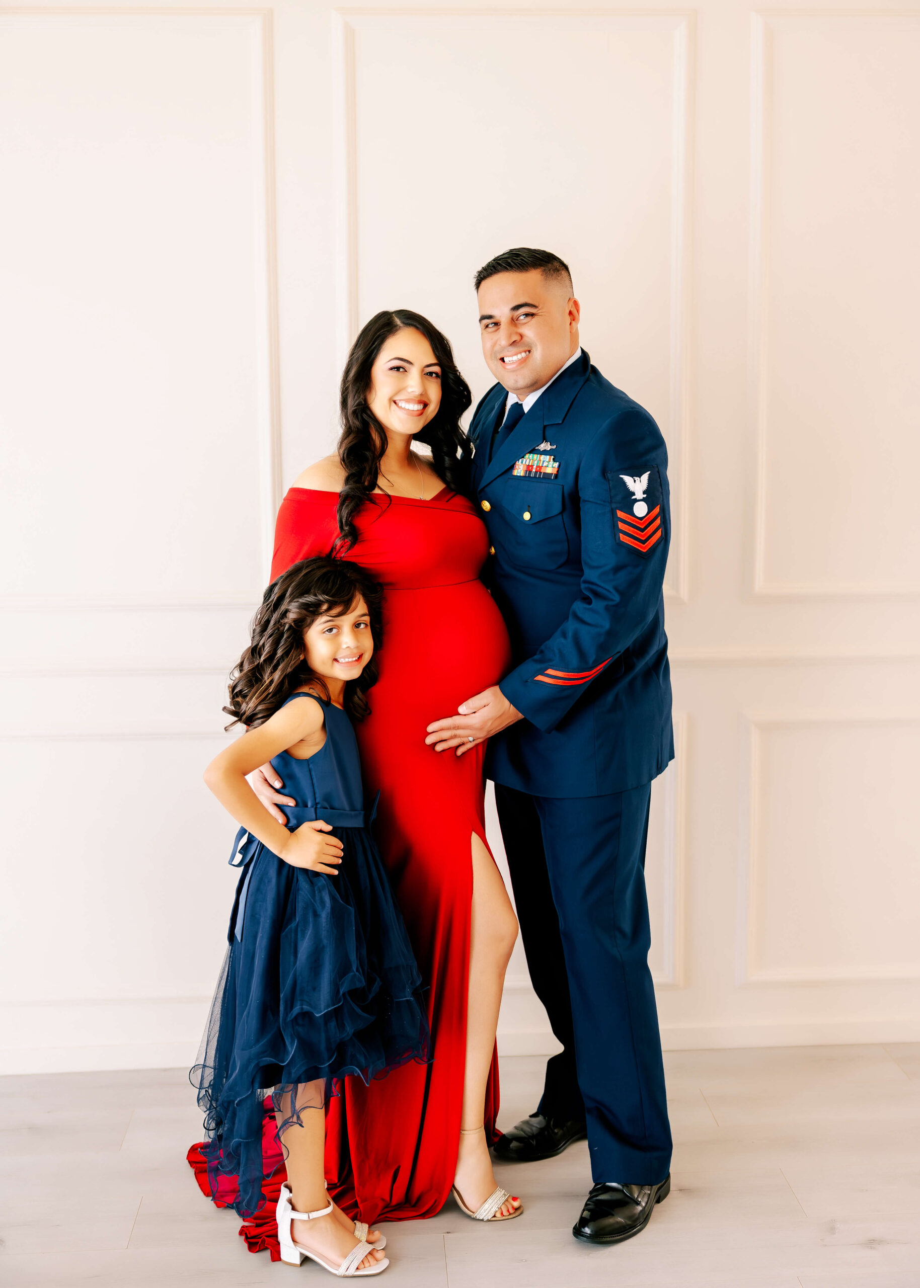 Military family expecting 2nd child posed together in Orange County, CA studio by Ashley Nicole Photography.